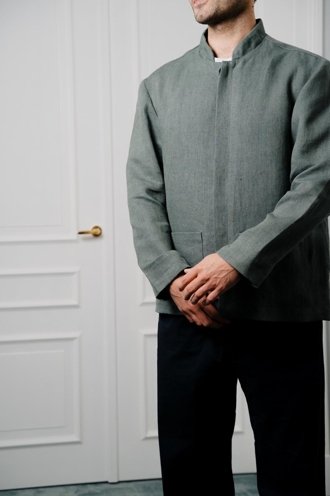 Green professional uniform jacket in natural textile, clean and structured design for hospitality staff