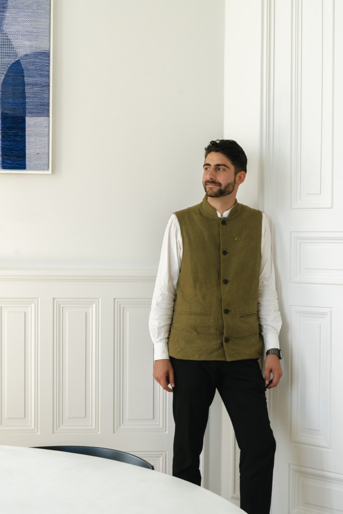Hospitality staff wearing a professional uniform vest in natural fabric at les hauts de sancerre, contemporary hotel workwear
