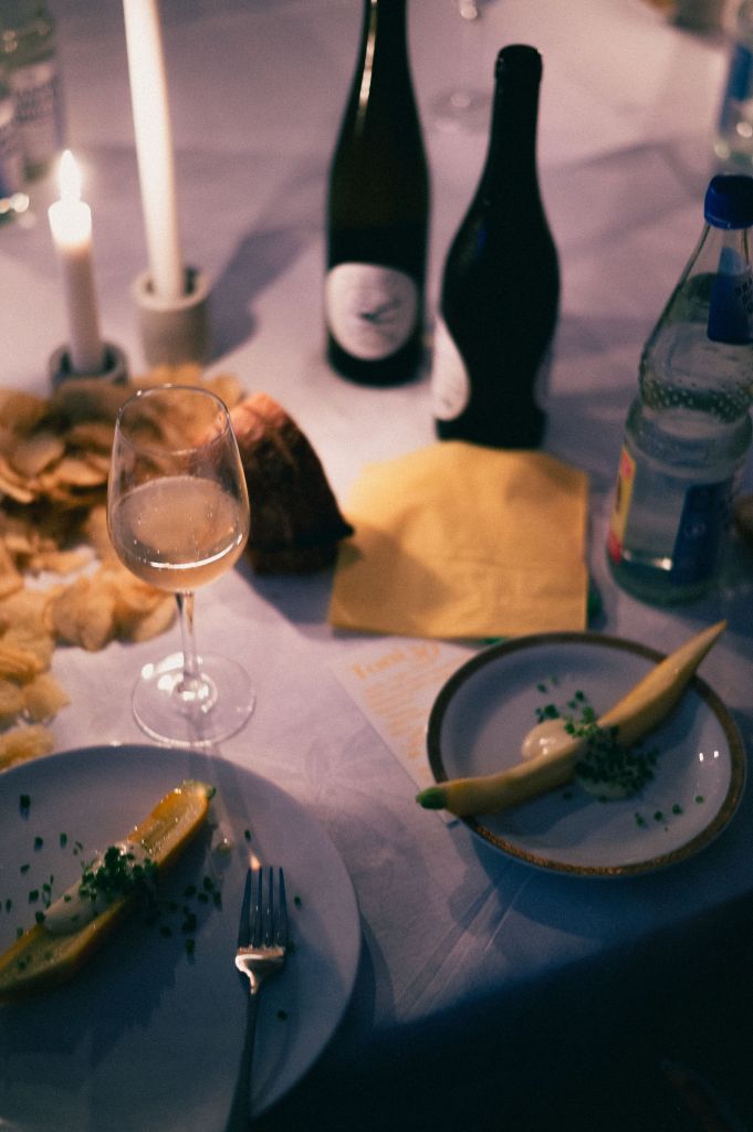 Restaurant dinner table with yellow accents in food and textiles, warm hospitality atmosphere