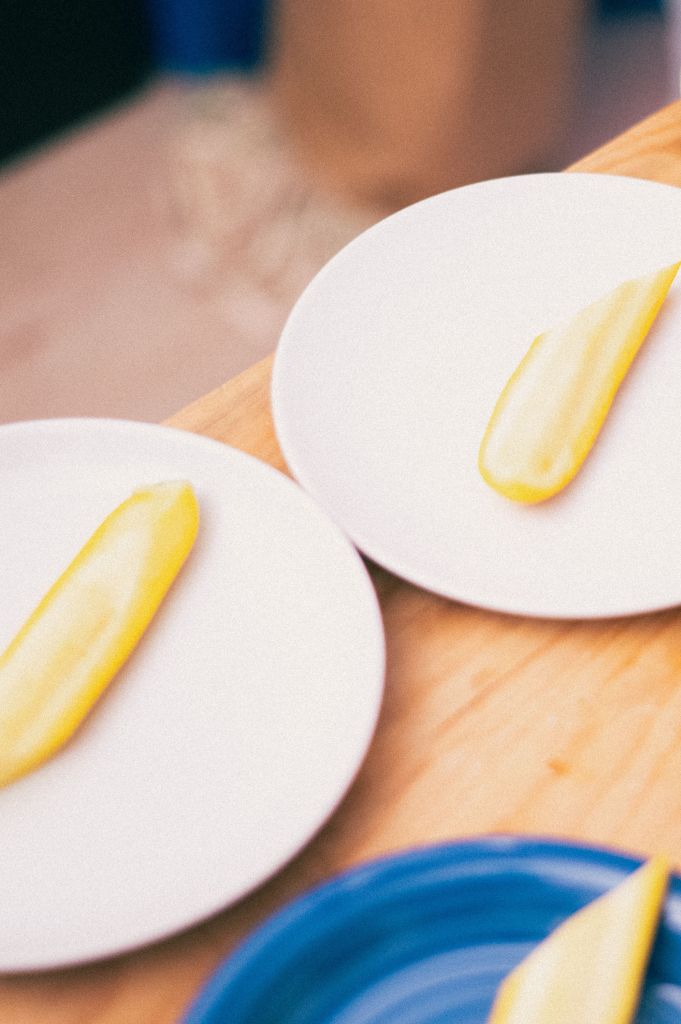 Minimalist plate presentation with yellow vegetables, fine dining detail in a hospitality environment