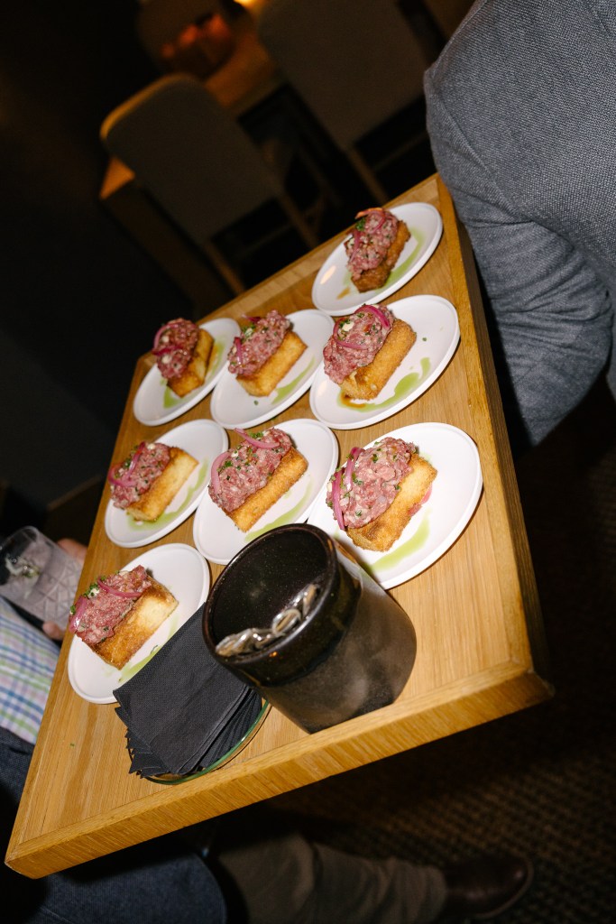 Small plates with prepared food served on a tray during a restaurant event