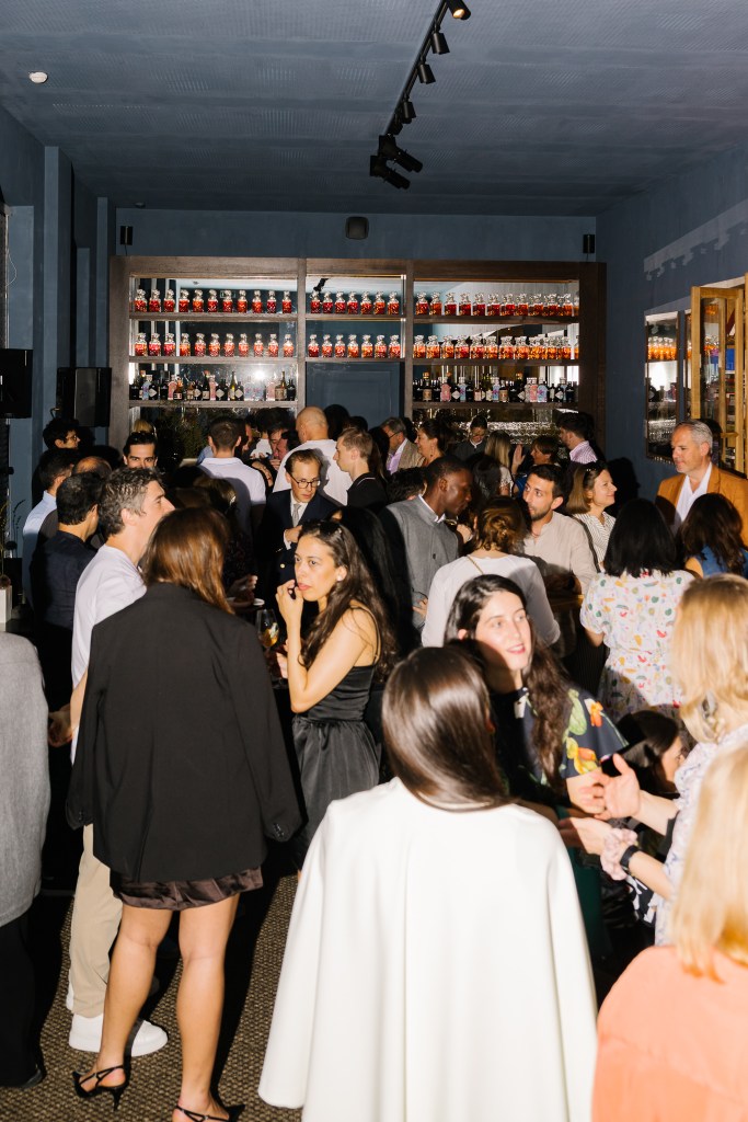 Guests gathered at a hospitality event inside a restaurant space, social atmosphere during evening service