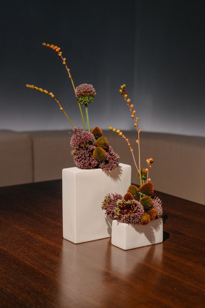 Minimalist floral arrangement on a restaurant table, decorative detail for hospitality interior design